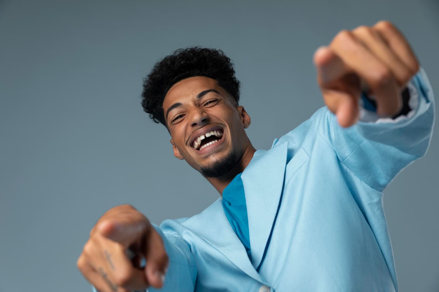 Happy man in light blue outfit